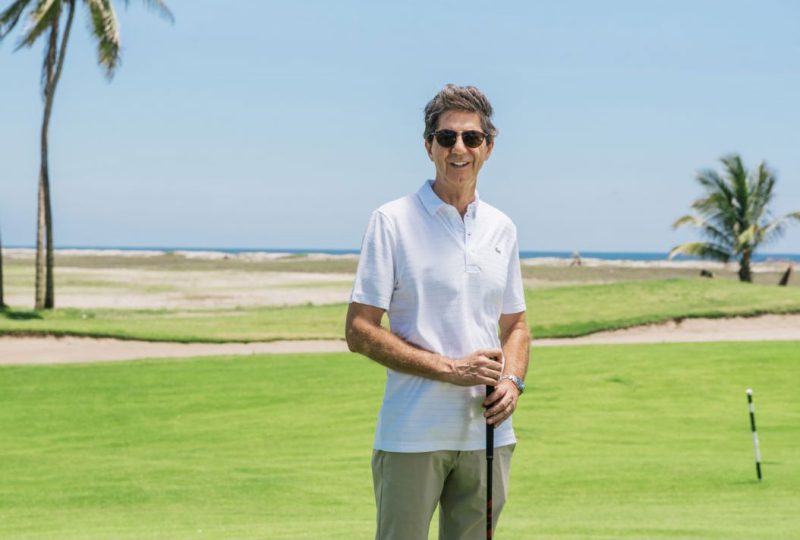 A businessman enjoying a round of golf in Mazatlán, Mexico, highlighting the region’s high quality of life.