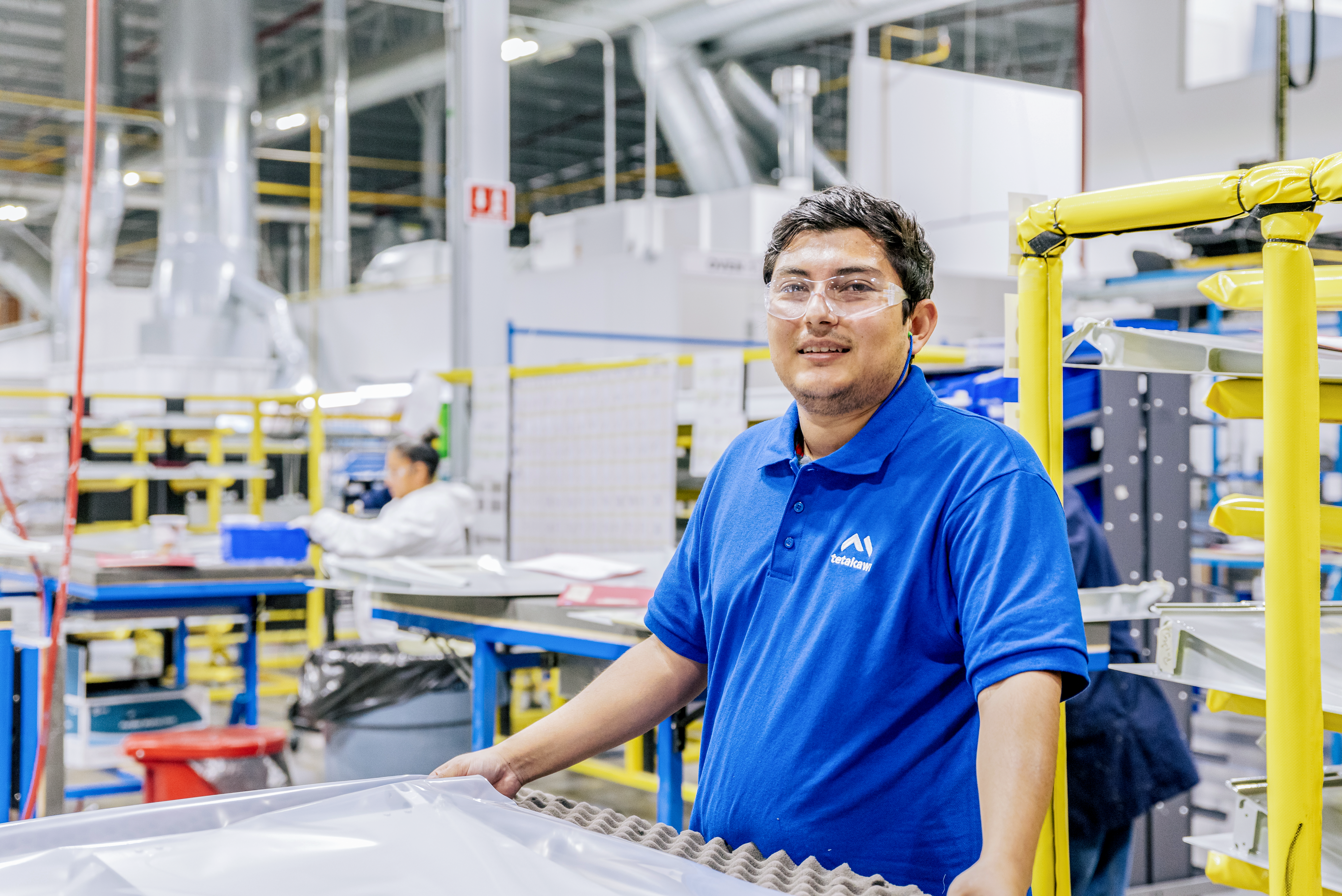 Manufacturing worker in Mazatlán, Mexico, inside a Tetakawi-supported facility.