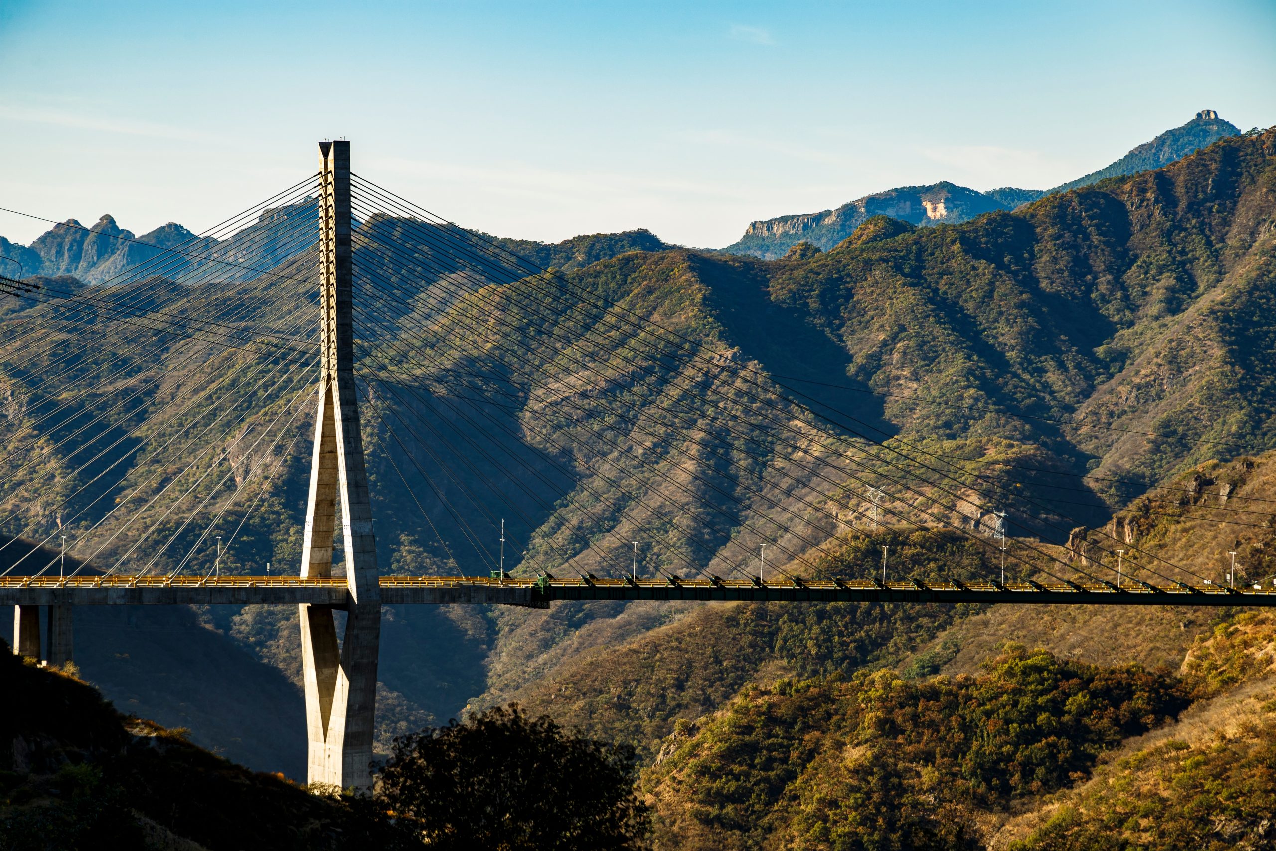 Aerial view of a modern cable-stayed bridge in Mazatlán, showcasing key highway infrastructure that connects the city to major domestic and international markets.